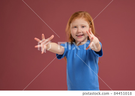 Portrait of cute redhead emotional little girl on red background Portrait of cute redhead emotional little girl on red background 84451018