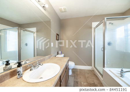 Bathroom interior with vanity sink with mirror and shower stall with aluminum frame 84451191