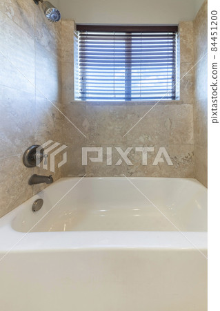 Small space bathroom with ceramic bathtub and a wall mounted shower head and faucet Small space bathroom with ceramic bathtub and a wall mounted shower head and faucet 84451200