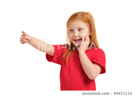 Education, school and imaginary screen concept - cute little girl pointing in the air or imaginary screen 84451219