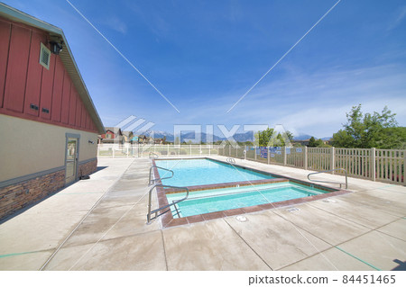 Residential community adult and kid swimming pool with mountain and sky view Residential community adult and kid swimming pool with mountain and sky view 84451465