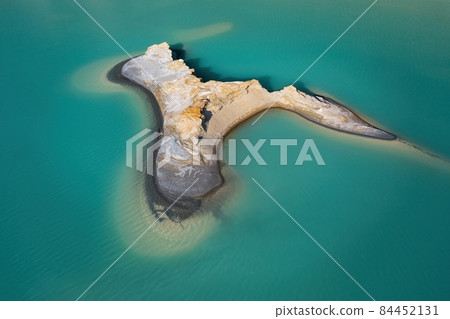 Drone view of the turquoise lake formed as a result of mining waste 84452131