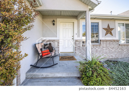 Front exterior of a house with bricks and ornament 84452163