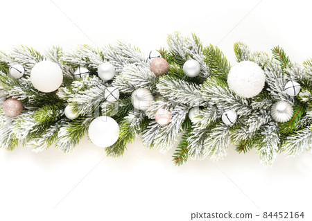 Christmas banner with white baubles in row on snowy evergreen branches. Christmas banner with white baubles in row on snowy evergreen branches. 84452164