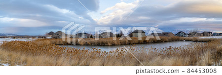 Large houses in a residential area with pond at Saratoga Springs in Utah 84453008
