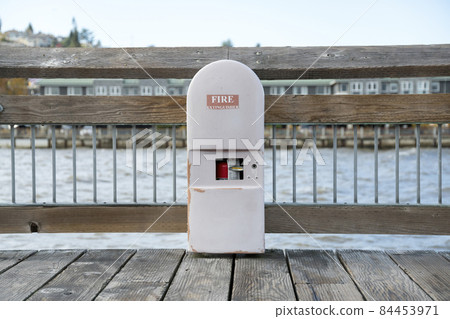 Fire extinguisher inside an arched cabinet on a dock in Tacoma, Washington Fire extinguisher inside an arched cabinet on a dock in Tacoma, Washington 84453971