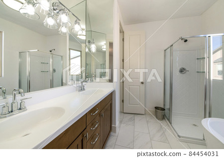 Contemporary white bathroom with marble flooring and narrow white door Contemporary white bathroom with marble flooring and narrow white door 84454031