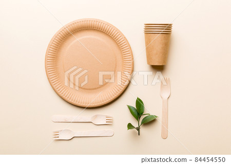 set of empty reusable disposable eco-friendly plates, cups, utensils on light white colored table background. top view. Biodegradable craft dishes. Recycling concept. Close-up 84454550