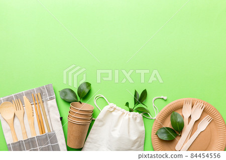 set of empty reusable disposable eco-friendly plates, cups, utensils on light white colored table background. top view. Biodegradable craft dishes. Recycling concept. Close-up 84454556