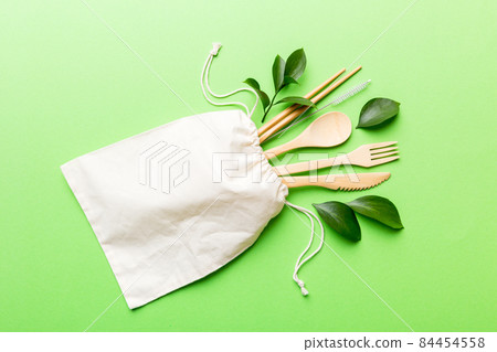 Eco friendly reusable recyclable white eco bag with kitchenware on Colored background. Concept zero waste Eco friendly reusable recyclable white eco bag with kitchenware on Colored background. Concept zero waste 84454558