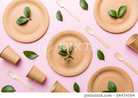 set of empty reusable disposable eco-friendly plates, cups, utensils on light white colored table background. top view. Biodegradable craft dishes. Recycling concept. Close-up 84454564