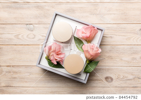 Composition with cosmetic products and beautiful roses on wooden background. Flat lay Composition with cosmetic products and beautiful roses on wooden background. Flat lay 84454792