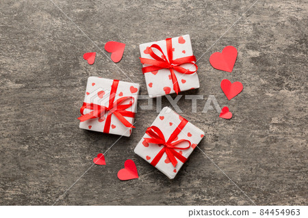 Valentine day composition Background: red gift box with bow and heart. Christmas present. View from above. Holday greeting card 84454963