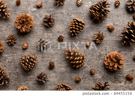 pine cones on colored table. natural holiday background with pinecones grouped together. Flat lay. Winter concept 84455159
