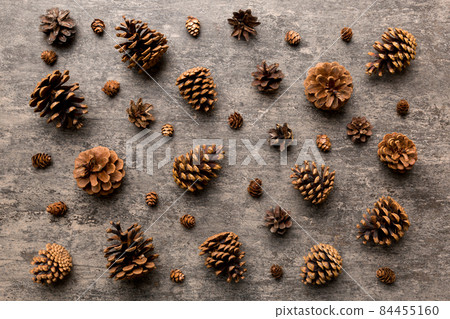 pine cones on colored table. natural holiday background with pinecones grouped together. Flat lay. Winter concept 84455160