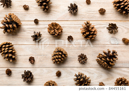pine cones on colored table. natural holiday background with pinecones grouped together. Flat lay. Winter concept 84455161
