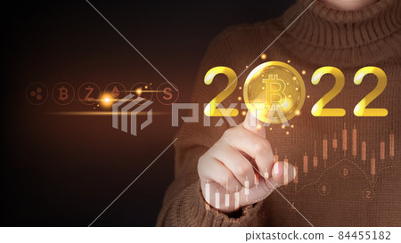 Future of digital cryptocurrency block chain market in 2022 concept. Smart investor pointing bitcoin symbol with 2022 golden number and other crypto currencies. Future of digital cryptocurrency block chain market in 2022 concept. Smart investor pointing bitcoin symbol with 2022 golden number and other crypto currencies. 84455182