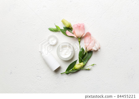 Composition with cosmetic products and beautiful roses on cement background. Flat lay Composition with cosmetic products and beautiful roses on cement background. Flat lay 84455221