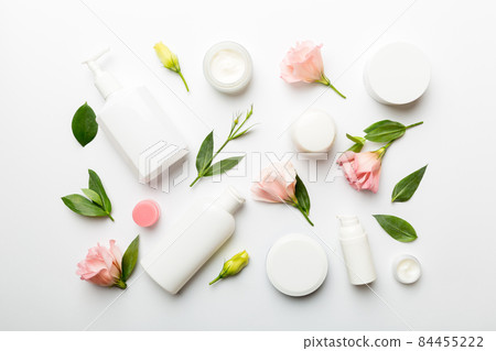 Composition with cosmetic products and beautiful roses on white background. Flat lay Composition with cosmetic products and beautiful roses on white background. Flat lay 84455222