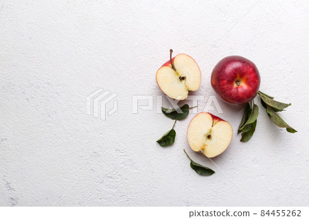 Fresh red apples with green leaves on wooden table. On wooden background. Top view free space for text Fresh red apples with green leaves on wooden table. On wooden background. Top view free space for text 84455262