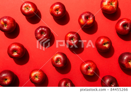 Many red apples on colored background, top view. Autumn pattern with fresh apple above view Many red apples on colored background, top view. Autumn pattern with fresh apple above view 84455266