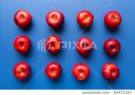 Many red apples on colored background, top view. Autumn pattern with fresh apple above view Many red apples on colored background, top view. Autumn pattern with fresh apple above view 84455267