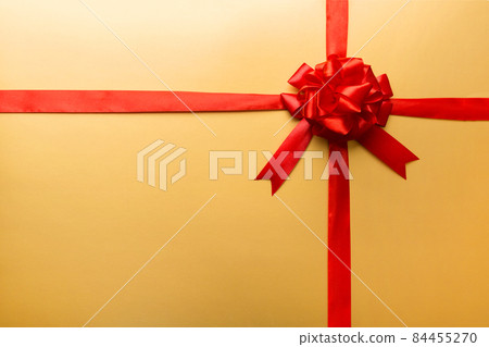 Top view of Red ribbon rolled and red bow isolated on colored background. Flat lay with copy space 84455270