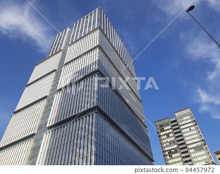 A towering skyscraper under the blue sky A towering skyscraper under the blue sky 84457972