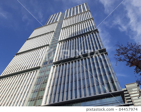 A towering skyscraper under the blue sky A towering skyscraper under the blue sky 84457974