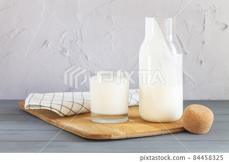 Jar of organic yogurt or sour milk with glass 84458325