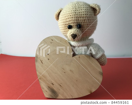 knitted bear with a heart made of wood. white and red background, bchb bear. a nice gift for a Belarusian. handmade bear of threads, crocheted knitted bear with a heart made of wood. white and red background, bchb bear. a nice gift for a Belarusian. handmade bear of threads, crocheted 84459161