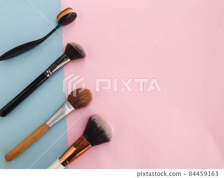tassels on a stylish pink and blue background. stylish place of work of a make-up artist. beautiful neat background. brushes for applying free-flowing and liquid textures tassels on a stylish pink and blue background. stylish place of work of a make-up artist. beautiful neat background. brushes for applying free-flowing and liquid textures 84459163