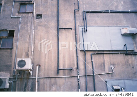 Complex building plumbing seen from the back alley 84459841