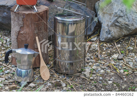 Pinto name of camping pot for cooking with moka pot coffee maker on a mountain day. 84460162