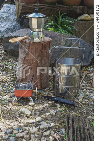 Pinto name of camping pot for cooking with moka pot coffee maker on a mountain day. Pinto name of camping pot for cooking with moka pot coffee maker on a mountain day. 84460172