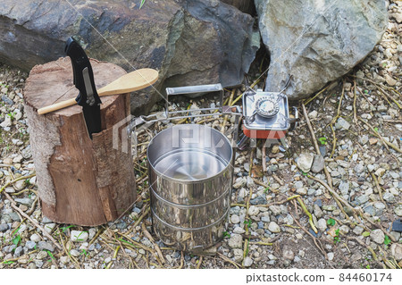 Pinto name of camping pot for cooking with Small stove on a mountain day. Pinto name of camping pot for cooking with Small stove on a mountain day. 84460174