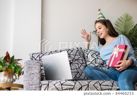 Woman celebrating birthday online at home Woman celebrating birthday online at home 84460253