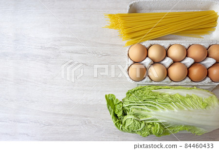 Grocery set for making breakfast, Fresh food on a wooden background with copy space. 84460433
