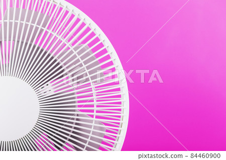 Electric fan in white with a modern design for cooling the room on a pink background. 84460900