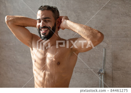 Handsome young Arabic male model enjoying taking hot shower Handsome young Arabic male model enjoying taking hot shower 84461275