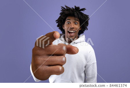 Funky black teen guy pointing index finger at camera, making big I CHOOSE YOU gesture on violet studio background Funky black teen guy pointing index finger at camera, making big I CHOOSE YOU gesture on violet studio background 84461374