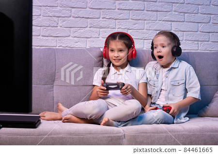 children playing video game with game console children playing video game with game console 84461665