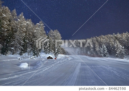 Skiing slope at night below starry sky Skiing slope at night below starry sky 84462598