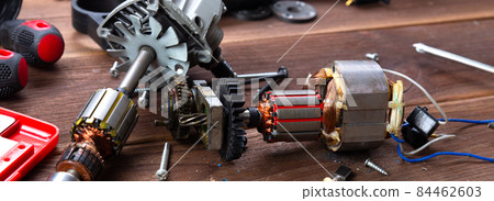 Details of electrical appliance and repair tools on a wooden table in a repair shop Details of electrical appliance and repair tools on a wooden table in a repair shop 84462603