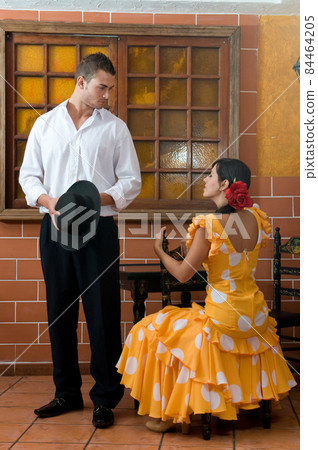 tipical spanish dancers with flamenco dresses in a bar tipical spanish dancers with flamenco dresses in a bar 84464205