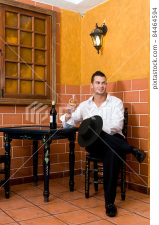 tipical spanish dancers with flamenco dresses in a bar 84464594