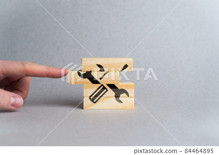 Concept for creating customer service and support from screwdriver and wrench icons and wooden blocks. Concept for creating customer service and support from screwdriver and wrench icons and wooden blocks. 84464895