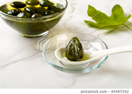 Close-up of preserved whole unripe fig on the spoon. 84465562