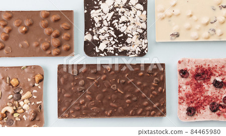 top view chocolate bars with nuts berries. High quality photo 84465980
