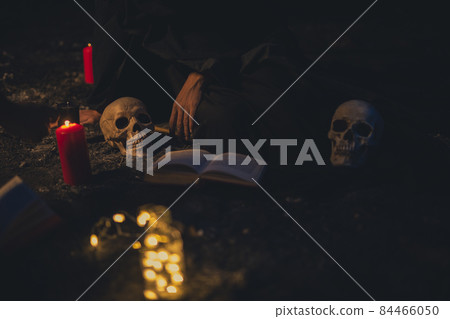 witchcraft arrangement with candle lights dark. High quality photo 84466050